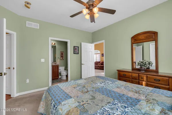 a bedroom with a bed and a dresser in it