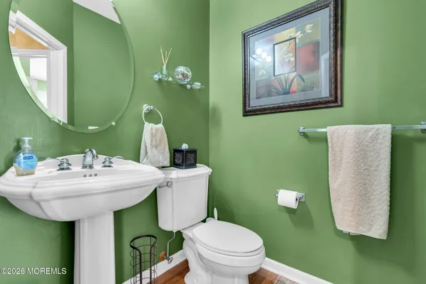 a bathroom with a sink mirror and toilet