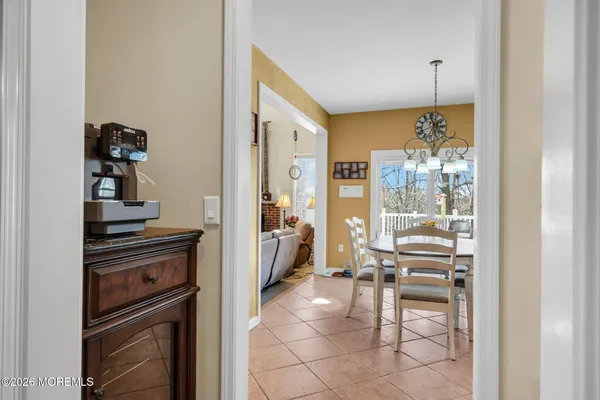 a kitchen with a refrigerator and chairs
