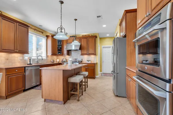 a kitchen with a sink cabinets and window