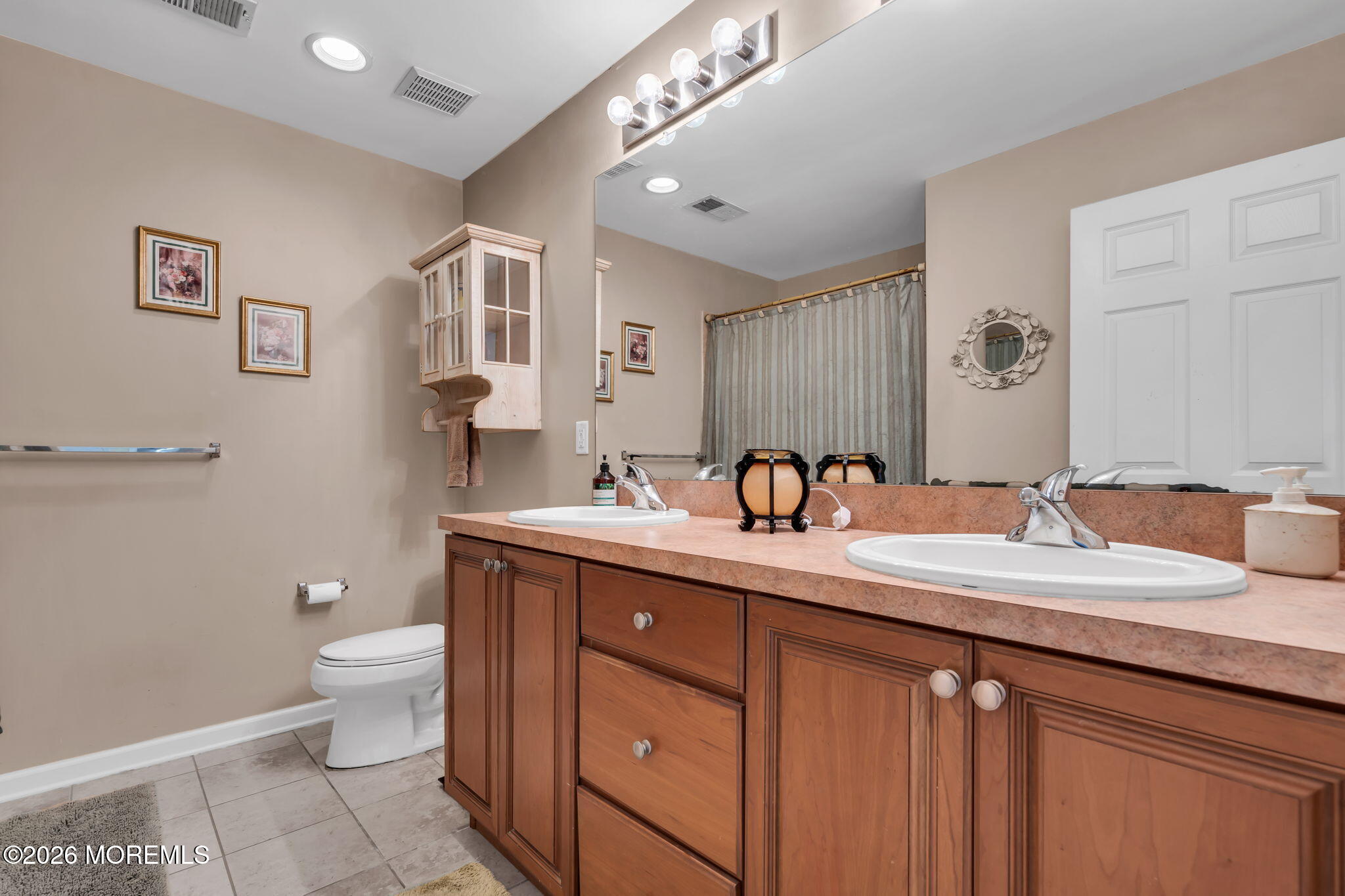 197 Benjamin Street Toms River, NJ 08755 - Photo 36 of 49 a bathroom with a granite countertop double vanity sink a mirror and a toilet