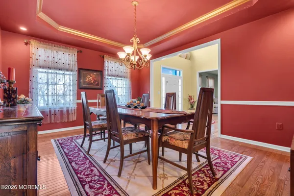 a view of a dining room with furniture and chandelier