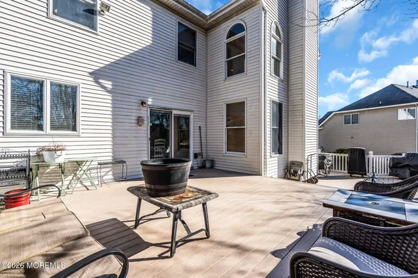 a view of a patio with table and chairs and barbeque