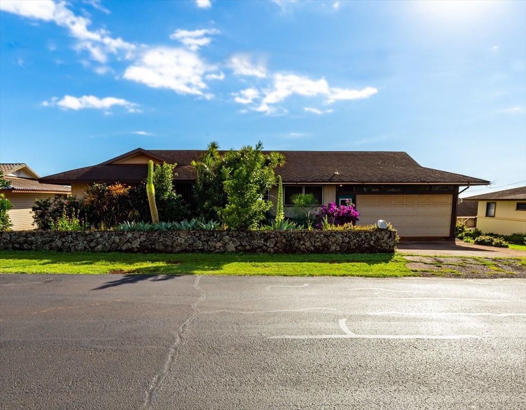180 Ulaula Road Eleele, HI 96705 - Photo 1 of 23 a front view of a house with a yard and garage