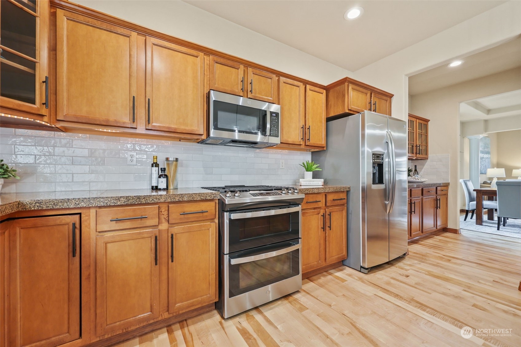 3206 172 Street Southeast Bothell, WA 98012 - Photo 12 of 35 a kitchen with stainless steel appliances granite countertop a refrigerator stove and sink
