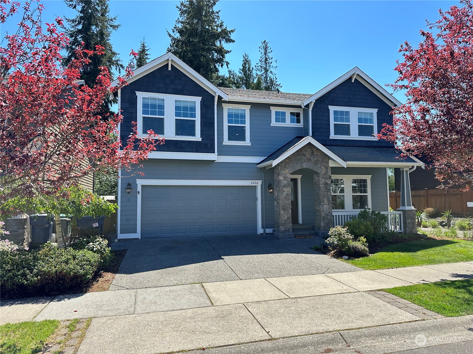 3206 172 Street Southeast Bothell, WA 98012 - Photo 2 of 35 a front view of a house with a garden