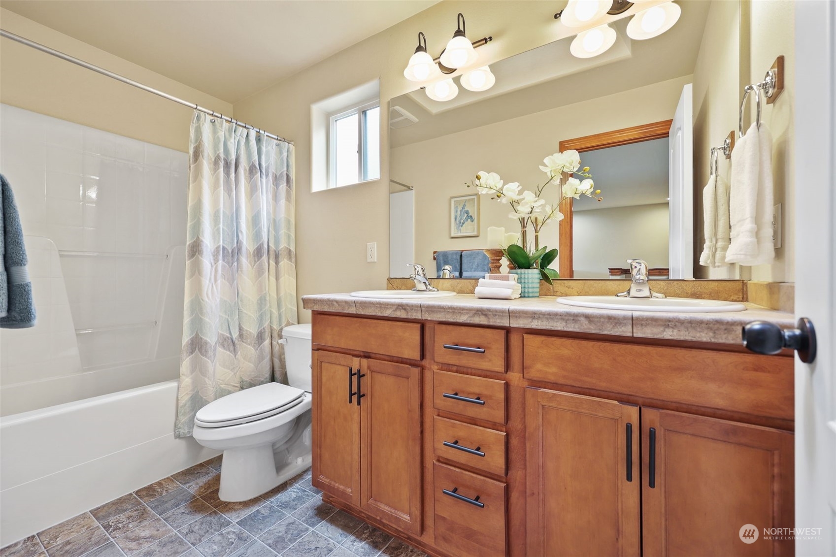 3206 172 Street Southeast Bothell, WA 98012 - Photo 23 of 35 a bathroom with a sink a toilet and a large mirror