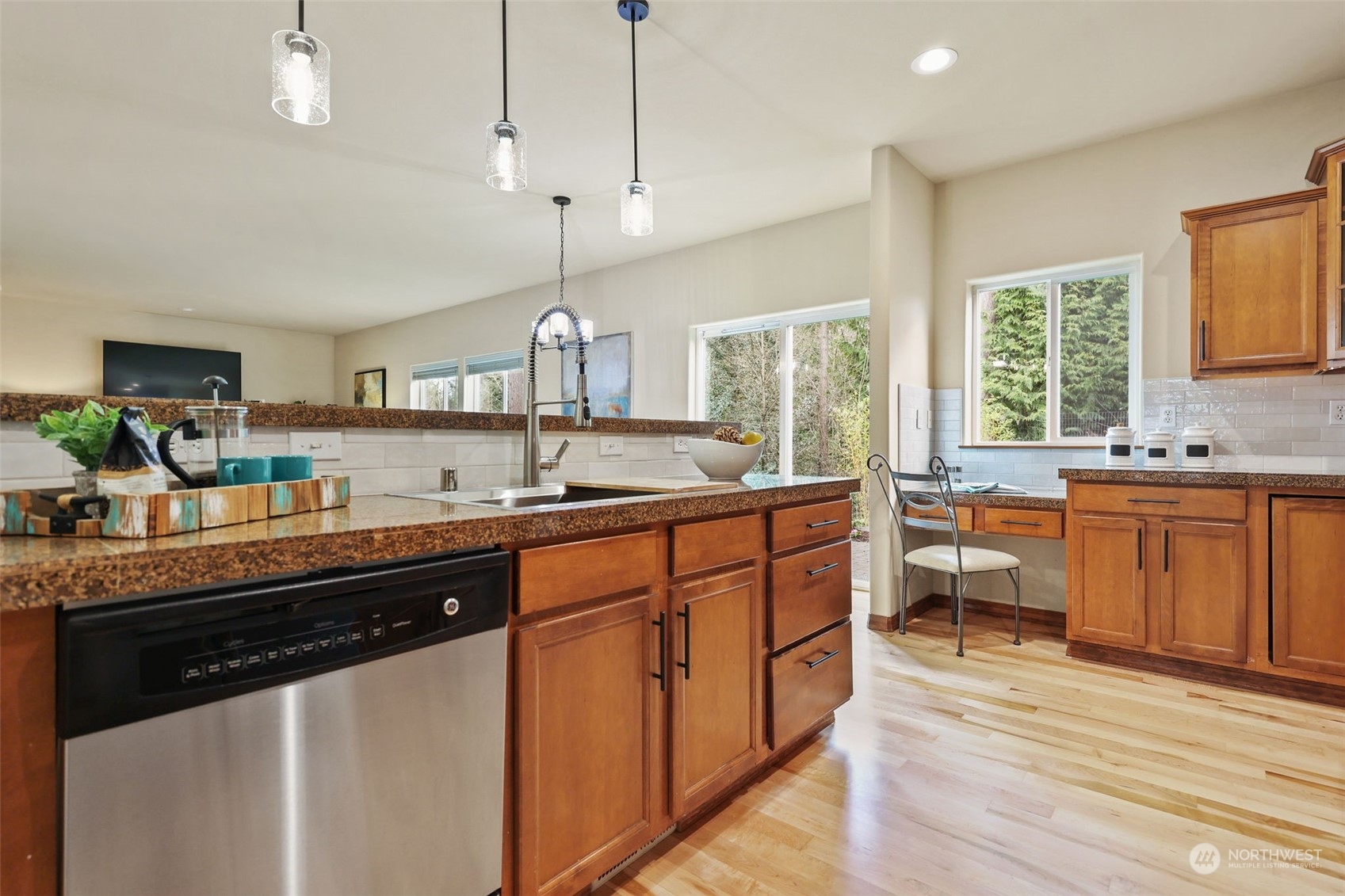 3206 172 Street Southeast Bothell, WA 98012 - Photo 10 of 35 a kitchen with stainless steel appliances granite countertop a sink a stove and a wooden floors