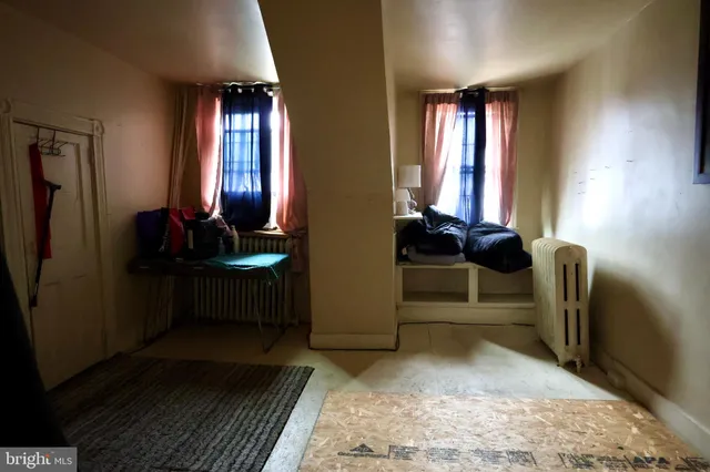 a view of hall way with furniture and window