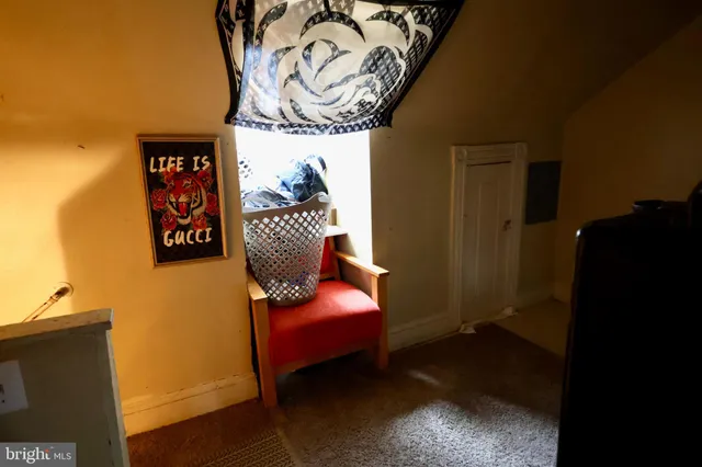 a room with furniture and paintings on the wall