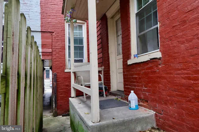 front view of a brick house with a fountain