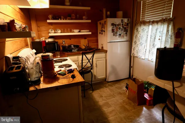 a kitchen with a refrigerator and a stove
