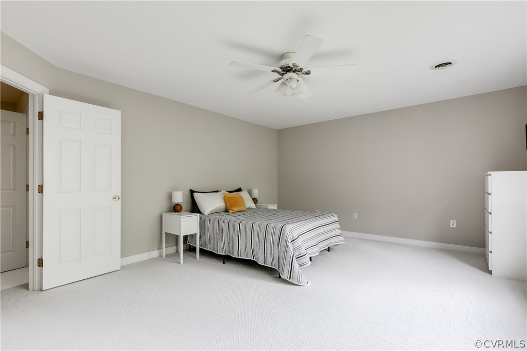 5304 West Shore Road Midlothian, VA 23112 - Photo 20 of 47 a room with a bed and chandelier fan