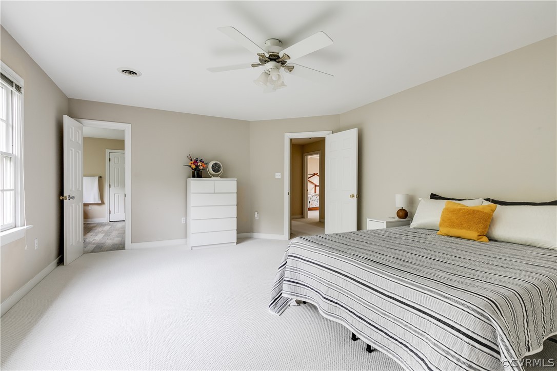 5304 West Shore Road Midlothian, VA 23112 - Photo 21 of 47 a bedroom with a bed and a chandelier