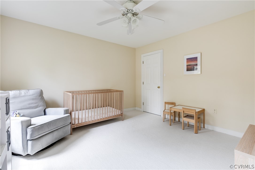 5304 West Shore Road Midlothian, VA 23112 - Photo 31 of 47 a living room with furniture and a baby crib