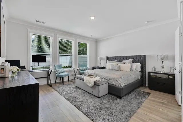 a bedroom with a bed and wooden floor