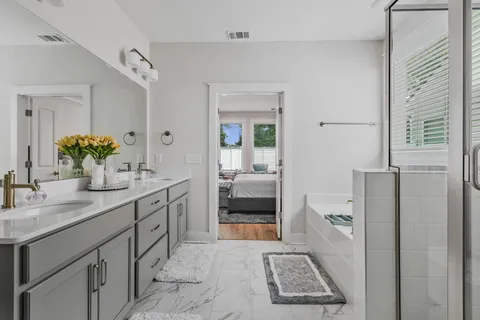 a bathroom with a sink a toilet and shower