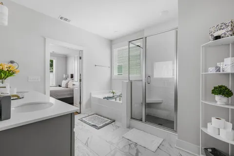a bathroom with a shower sink and mirror