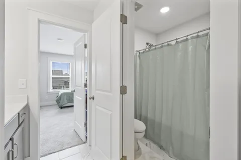 a bathroom with a shower and a toilet