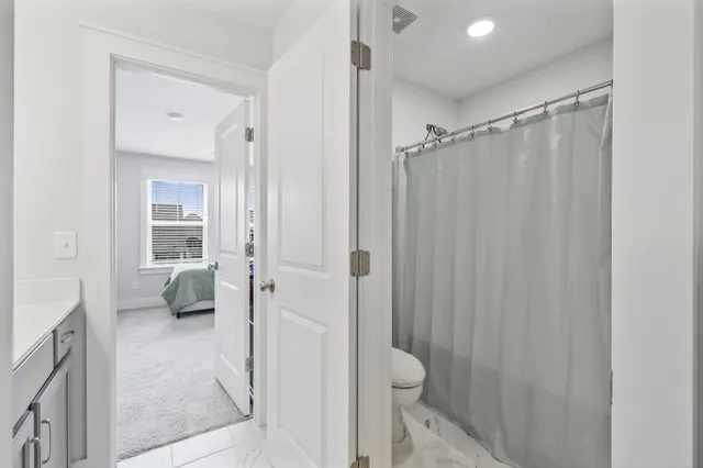 a bathroom with a shower and a toilet