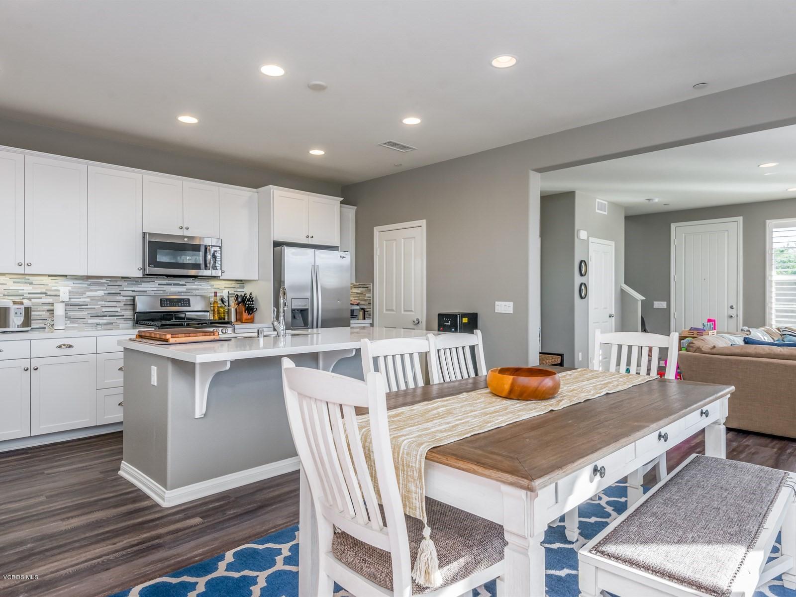 287 Stagetrail Road Camarillo, CA 93010 - Photo 1 of 30 a kitchen with a table chairs a sink dishwasher stove and cabinets with wooden floor