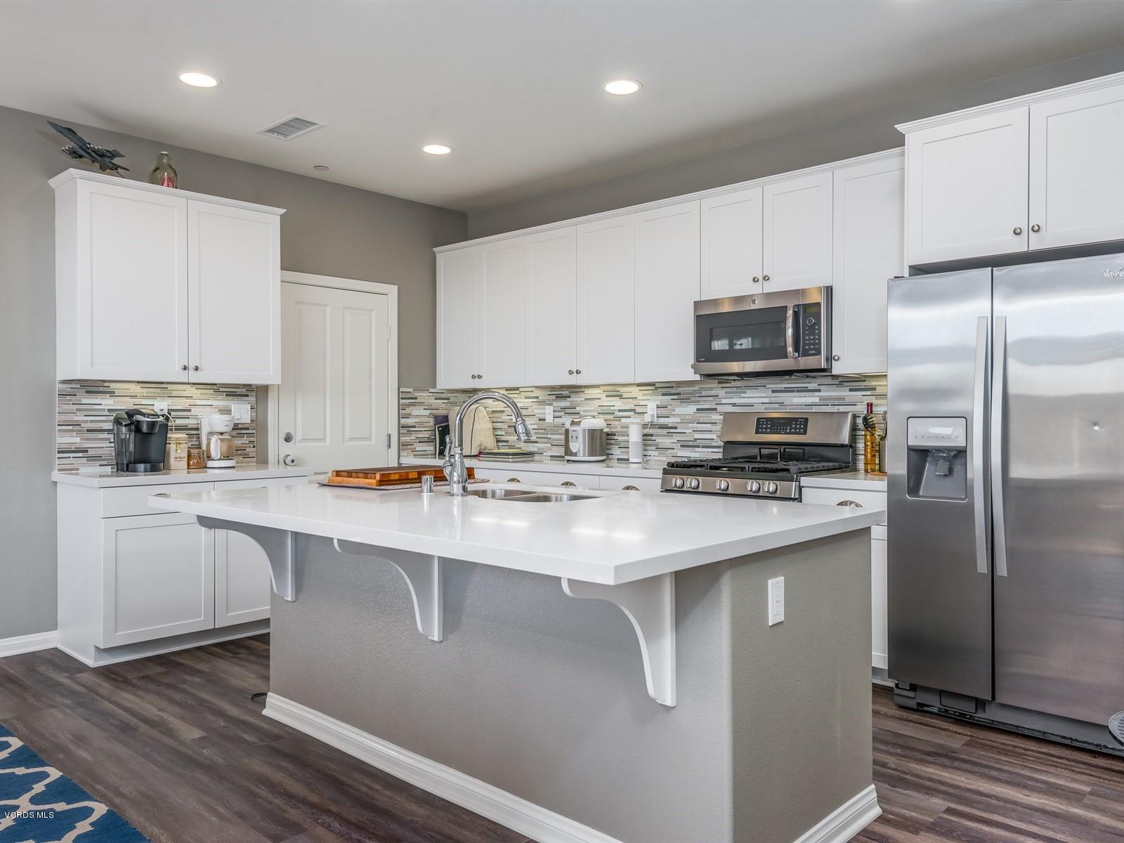 287 Stagetrail Road Camarillo, CA 93010 - Photo 2 of 30 a kitchen with stainless steel appliances a sink stove refrigerator and cabinets