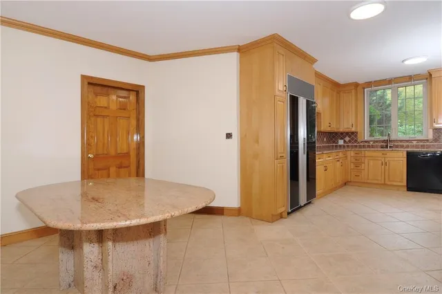 a kitchen with stainless steel appliances granite countertop a sink a refrigerator and a stove