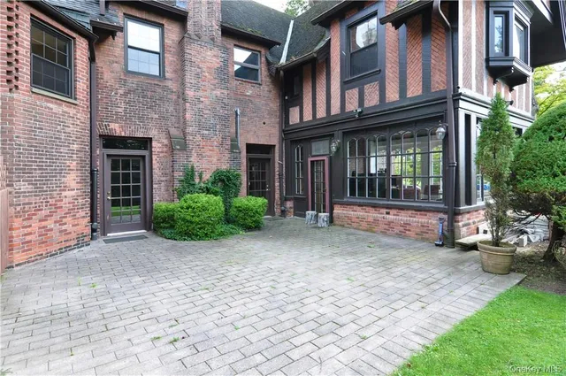 a view of a brick house with many windows