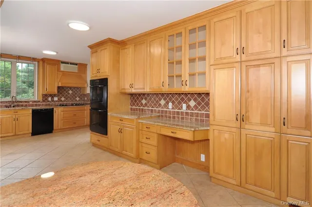 a kitchen with stainless steel appliances granite countertop a stove and a refrigerator