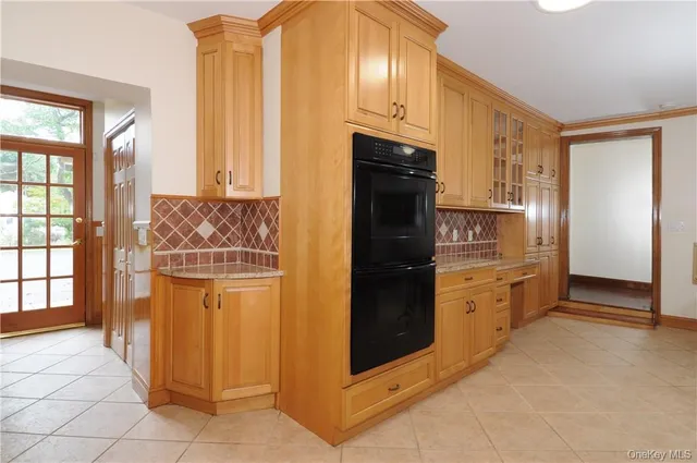 a kitchen with windows and refrigerator