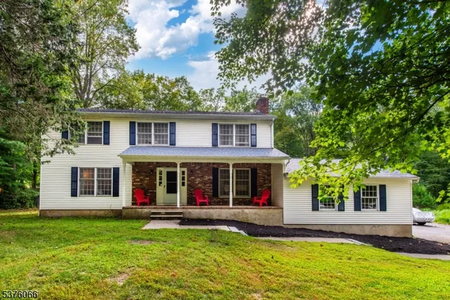 a view of a house with a yard patio and swimming pool
