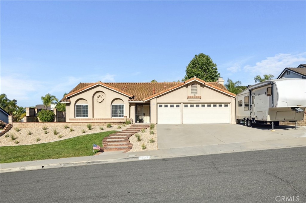 a view of a large house with a yard and large trees