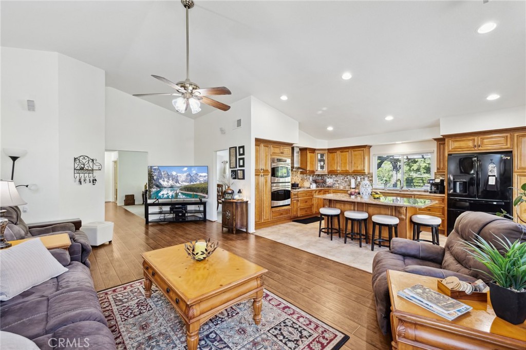 6752 Laurel Brook Drive Riverside, CA 92506 - Photo 15 of 53 a living room with furniture kitchen view and a chandelier