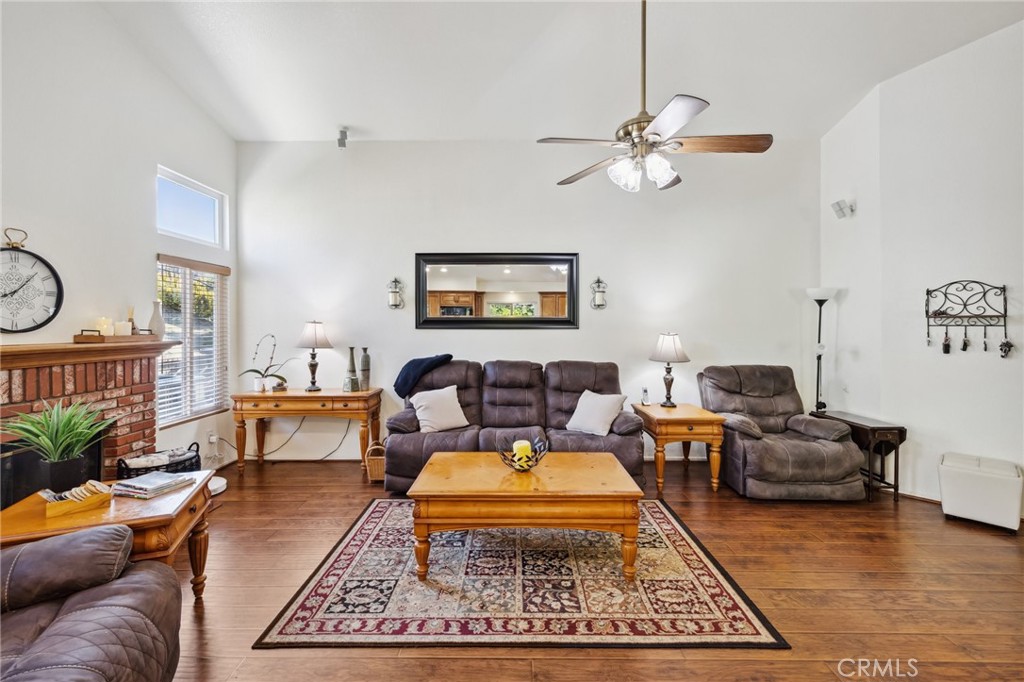 6752 Laurel Brook Drive Riverside, CA 92506 - Photo 16 of 53 a living room with furniture a rug and a chandelier