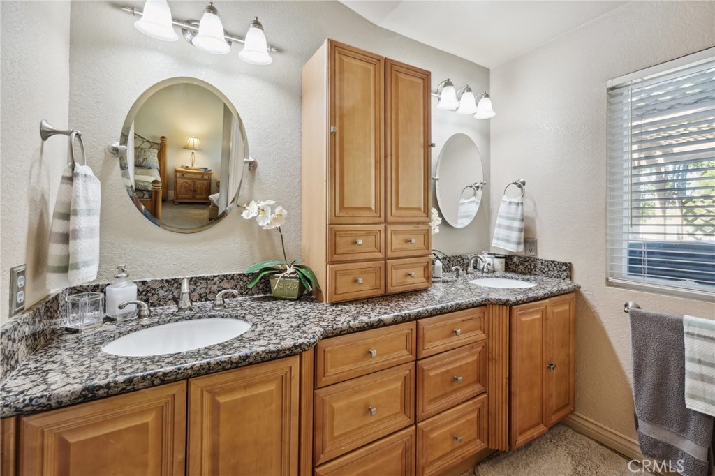 6752 Laurel Brook Drive Riverside, CA 92506 - Photo 22 of 53 a bathroom with a granite countertop double vanity sink and a mirror