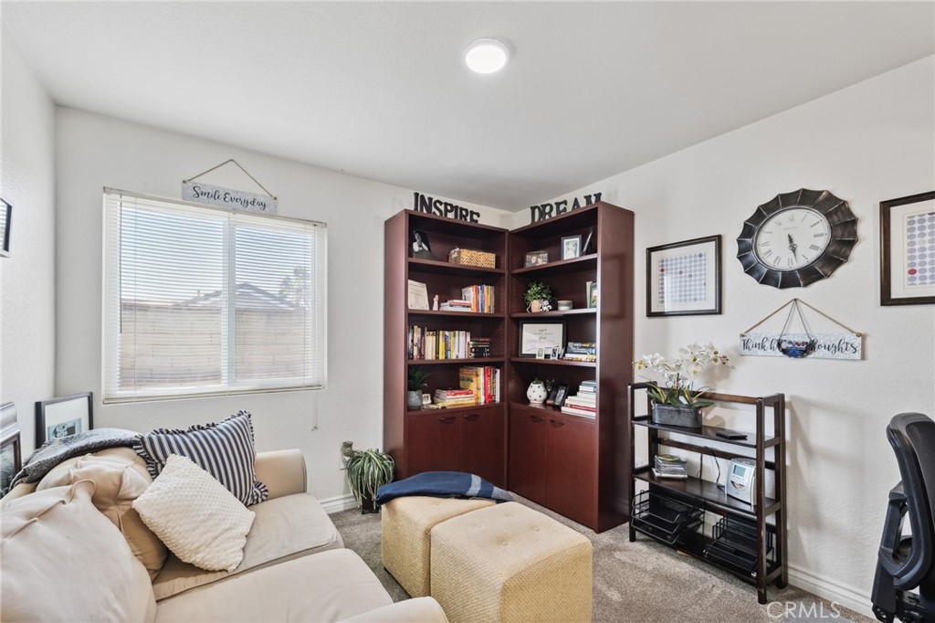 6752 Laurel Brook Drive Riverside, CA 92506 - Photo 35 of 53 a living room with furniture a window and a clock
