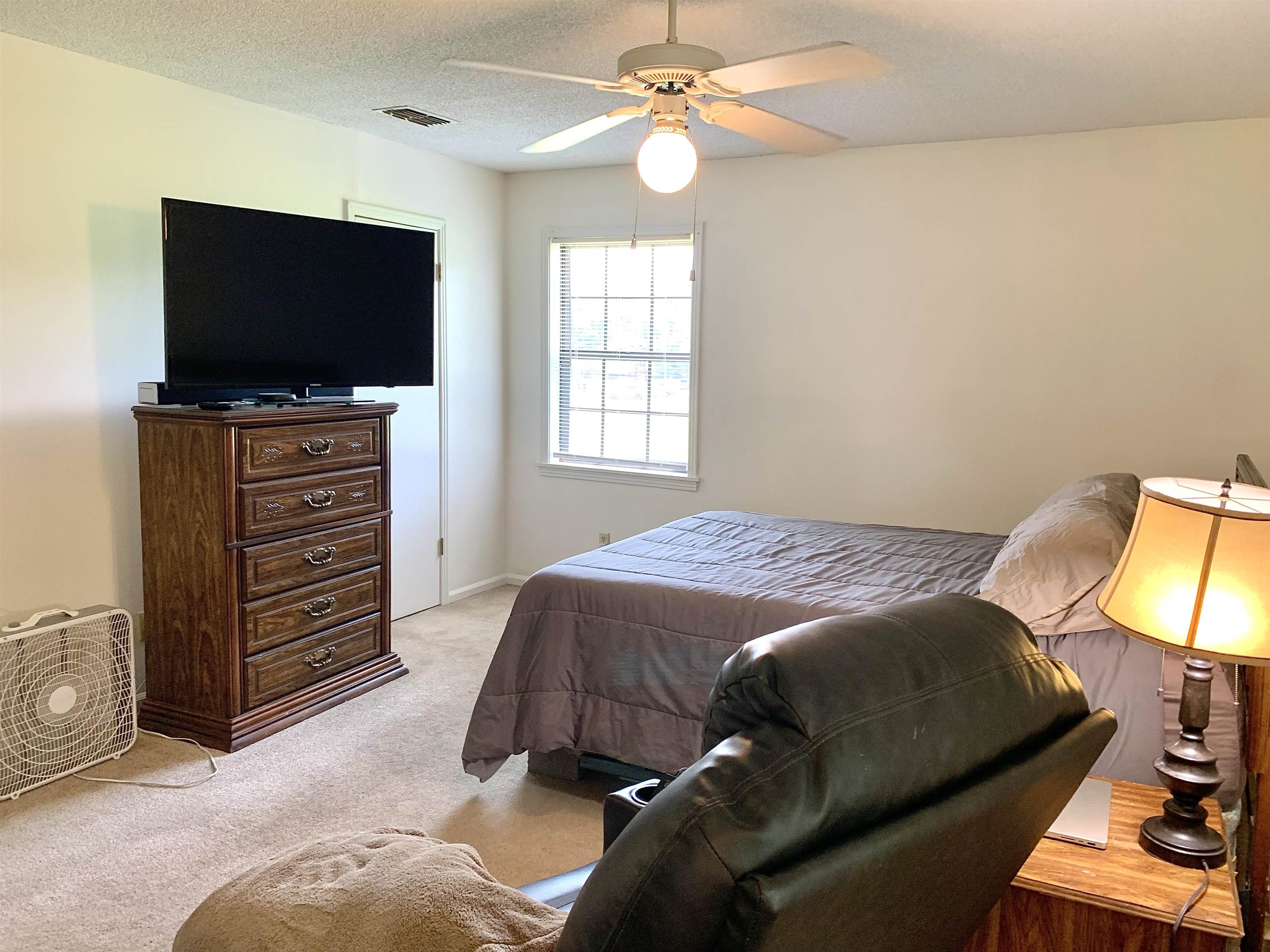 111 Robin Court Middleton, TN 38052 - Photo 12 of 23 a bedroom with a bed and a flat screen tv