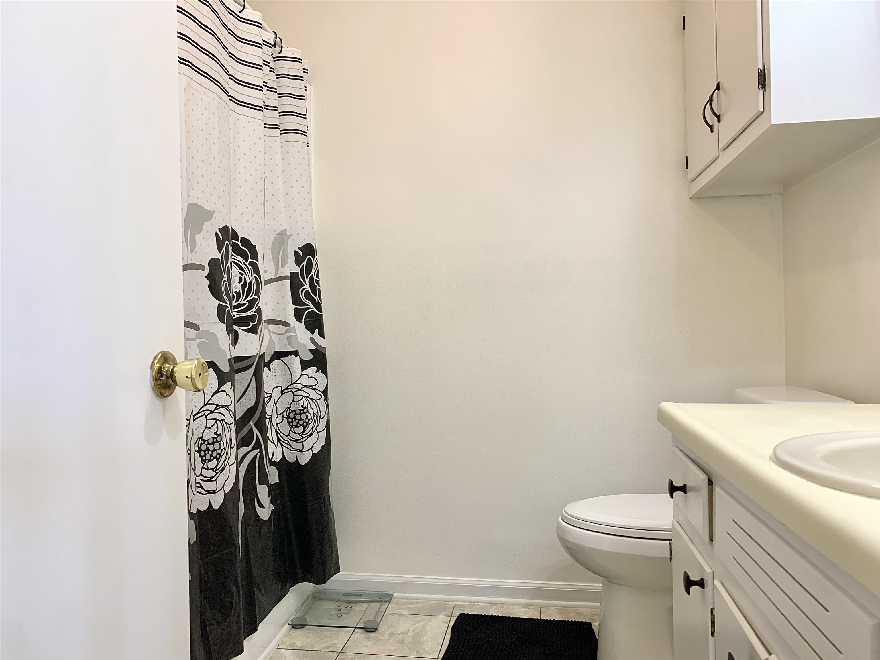 111 Robin Court Middleton, TN 38052 - Photo 14 of 23 a bathroom with a toilet and a shower curtain