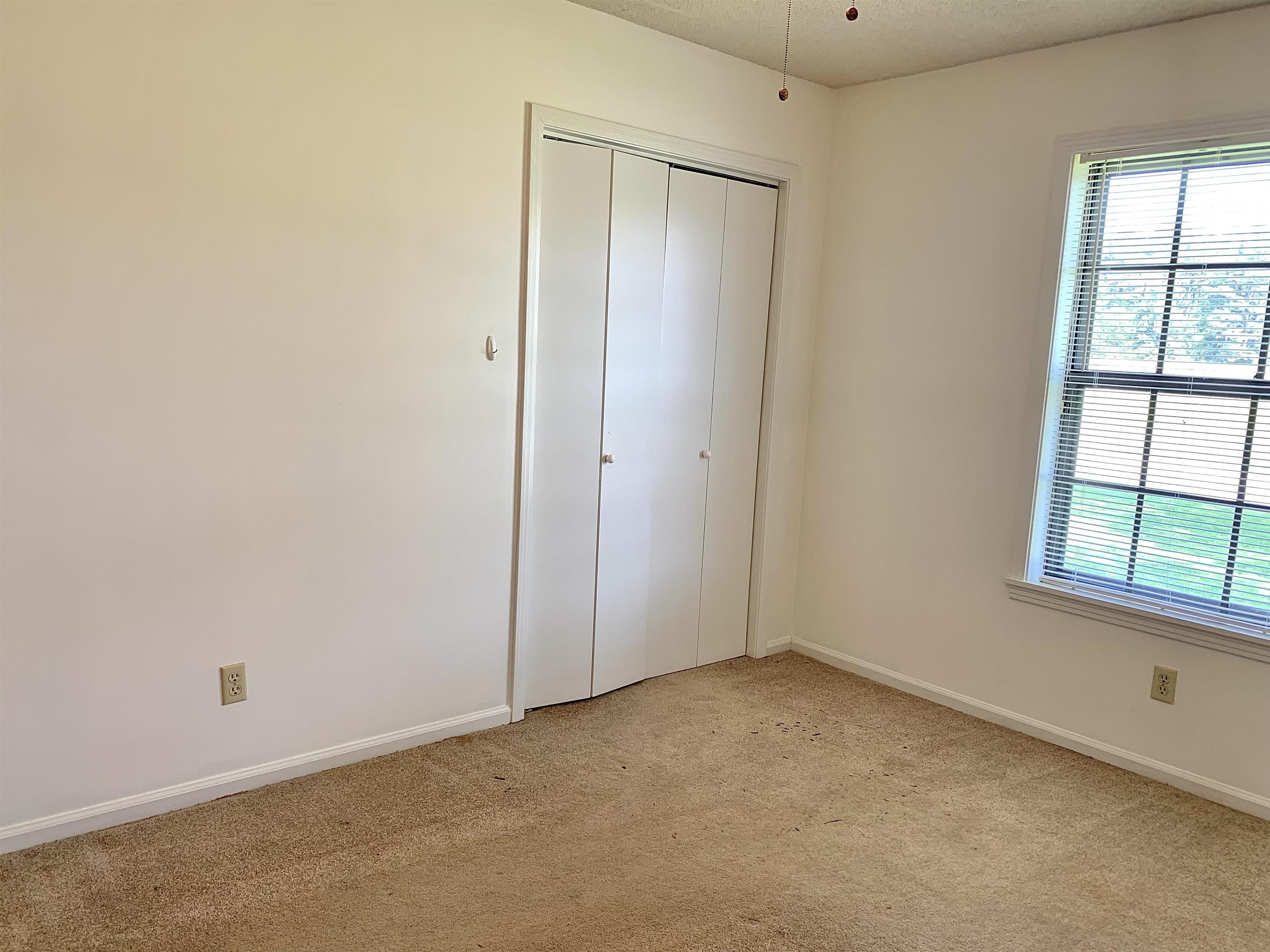 111 Robin Court Middleton, TN 38052 - Photo 17 of 23 an empty room with windows and closet