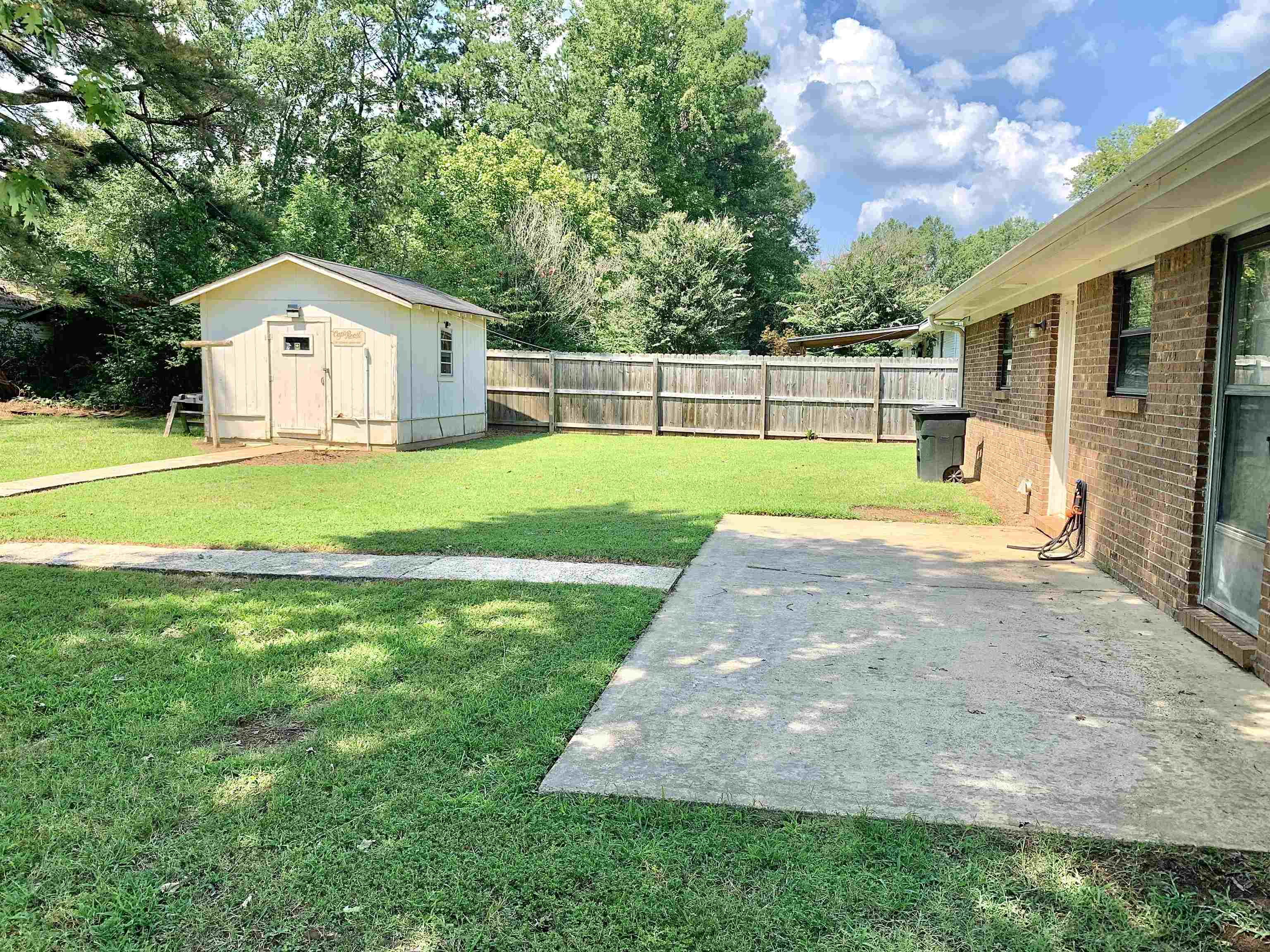 111 Robin Court Middleton, TN 38052 - Photo 19 of 23 a front view of a house with garden and yard