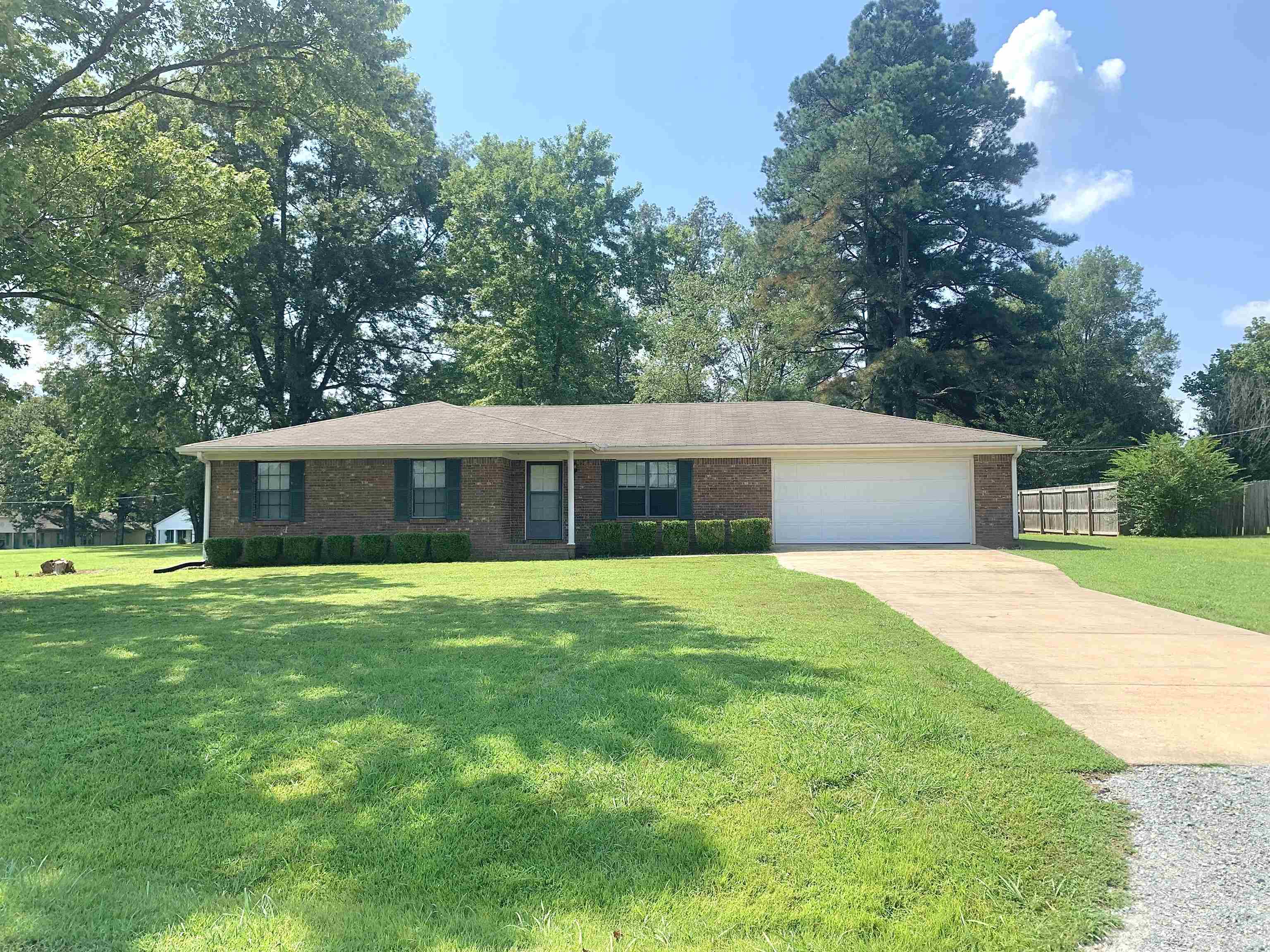 111 Robin Court Middleton, TN 38052 - Photo 2 of 23 a front view of house with yard and trees in the background