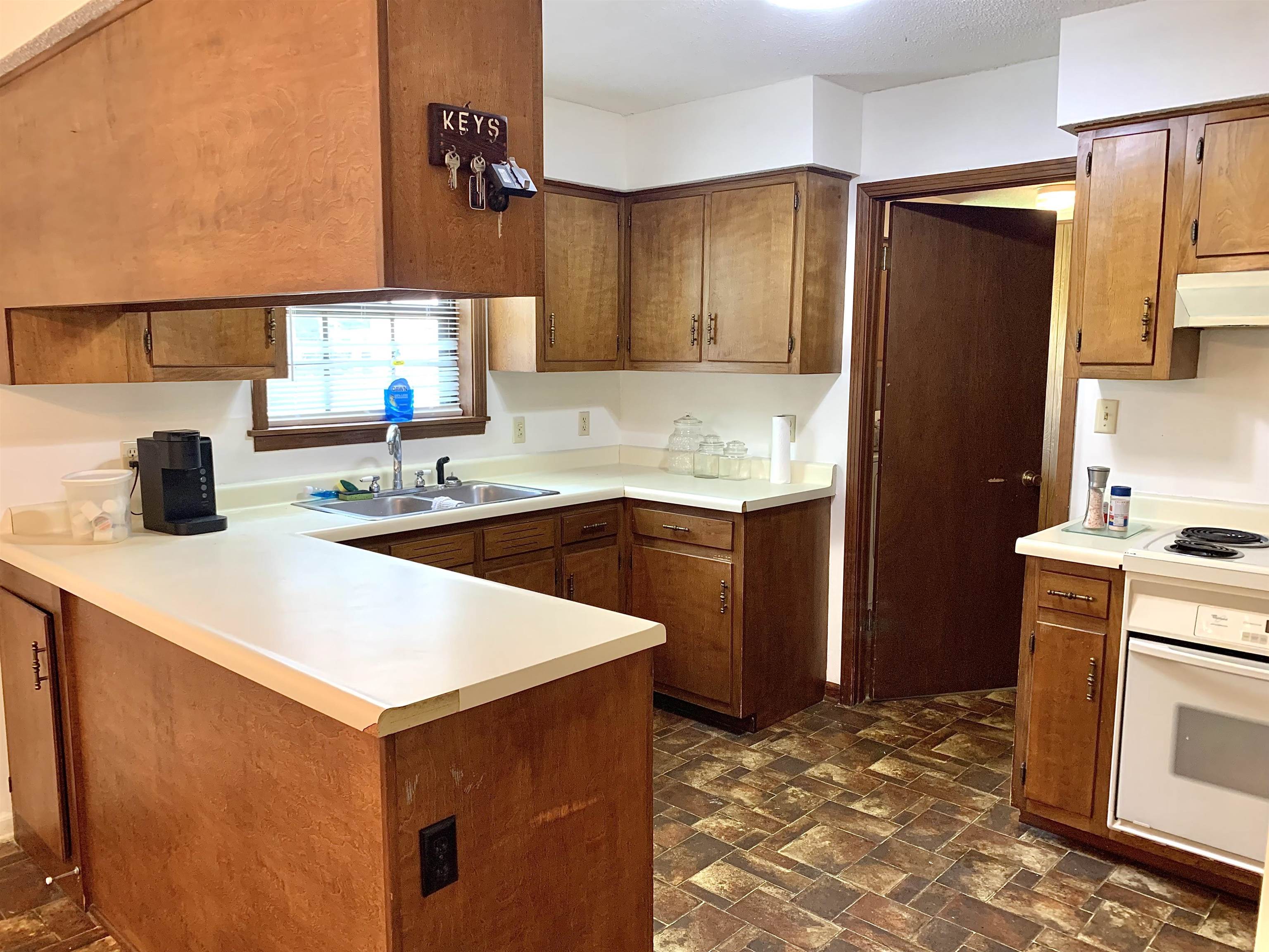 111 Robin Court Middleton, TN 38052 - Photo 6 of 23 a kitchen with stainless steel appliances a sink a stove and a refrigerator