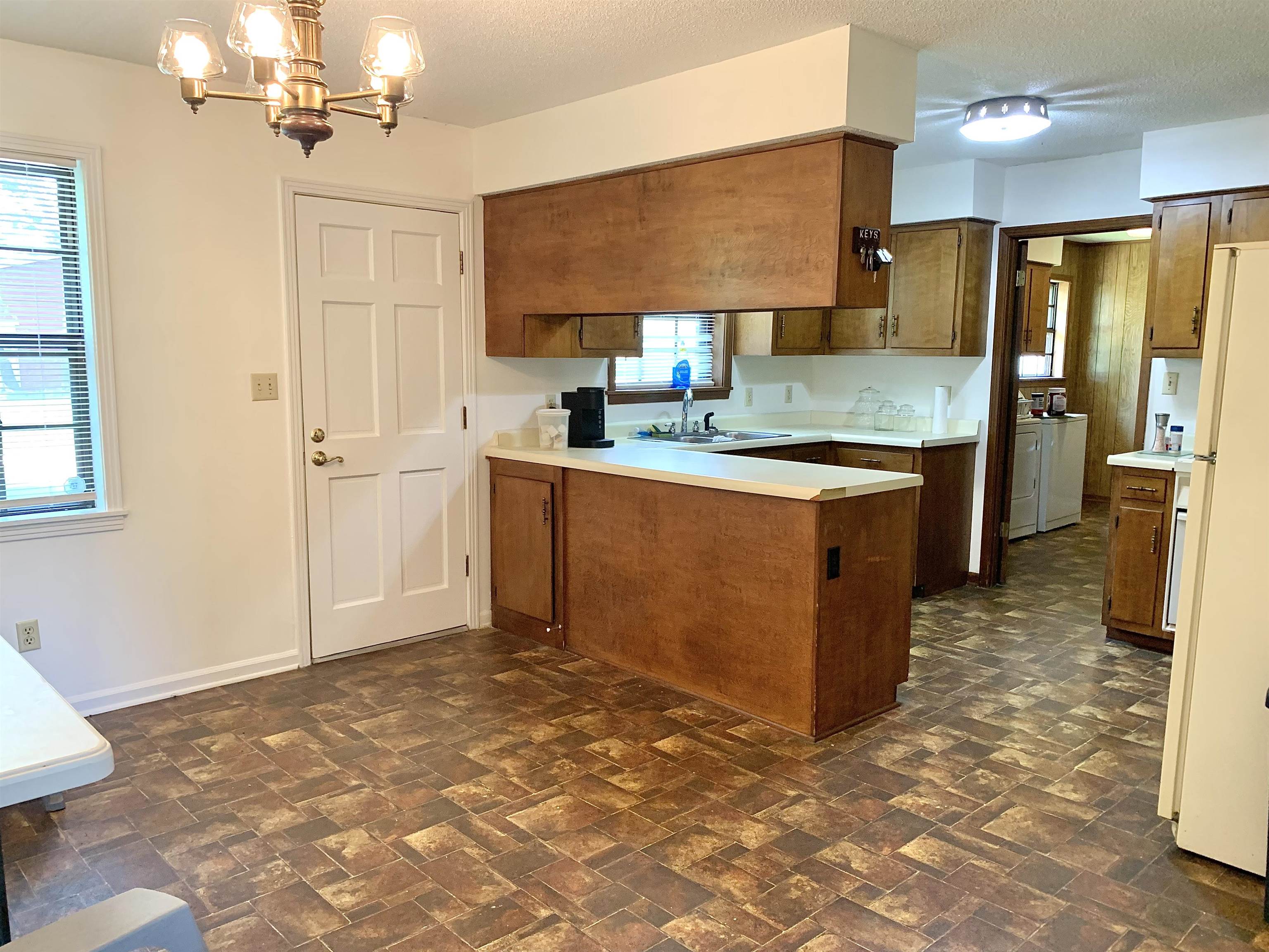111 Robin Court Middleton, TN 38052 - Photo 7 of 23 a kitchen with stainless steel appliances granite countertop a sink stove and refrigerator