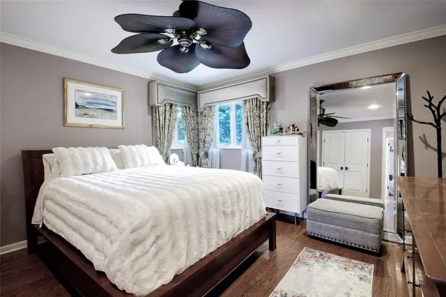 a spacious bedroom with a bed and a chandelier