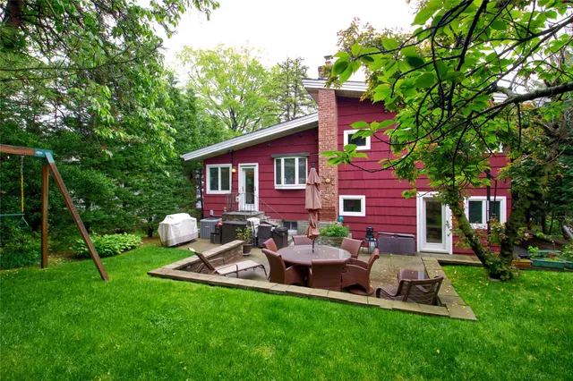 a view of a house with a backyard and a patio