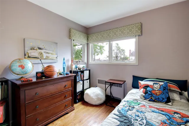 a bedroom with bed and a window