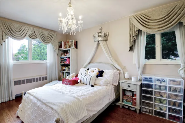 a bedroom with a bed and a chandelier