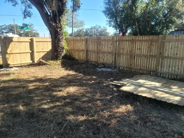 a view of a yard with a large tree