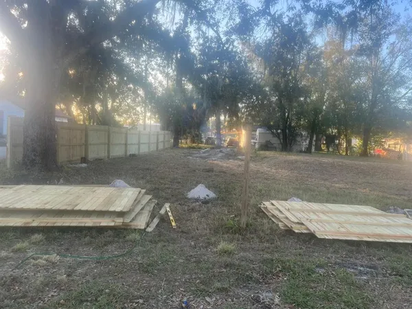 a backyard of a house with table and chairs