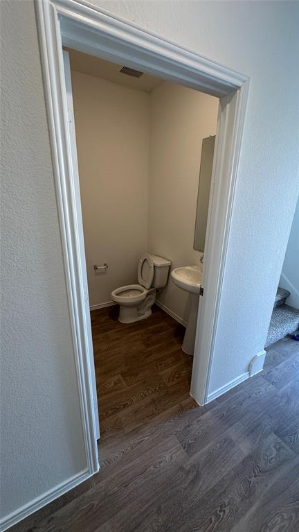 204 Inks Lane Kyle, TX 78640 - Photo 6 of 25 A compact and functional guest bath offers convenience with a pedestal sink and toilet.